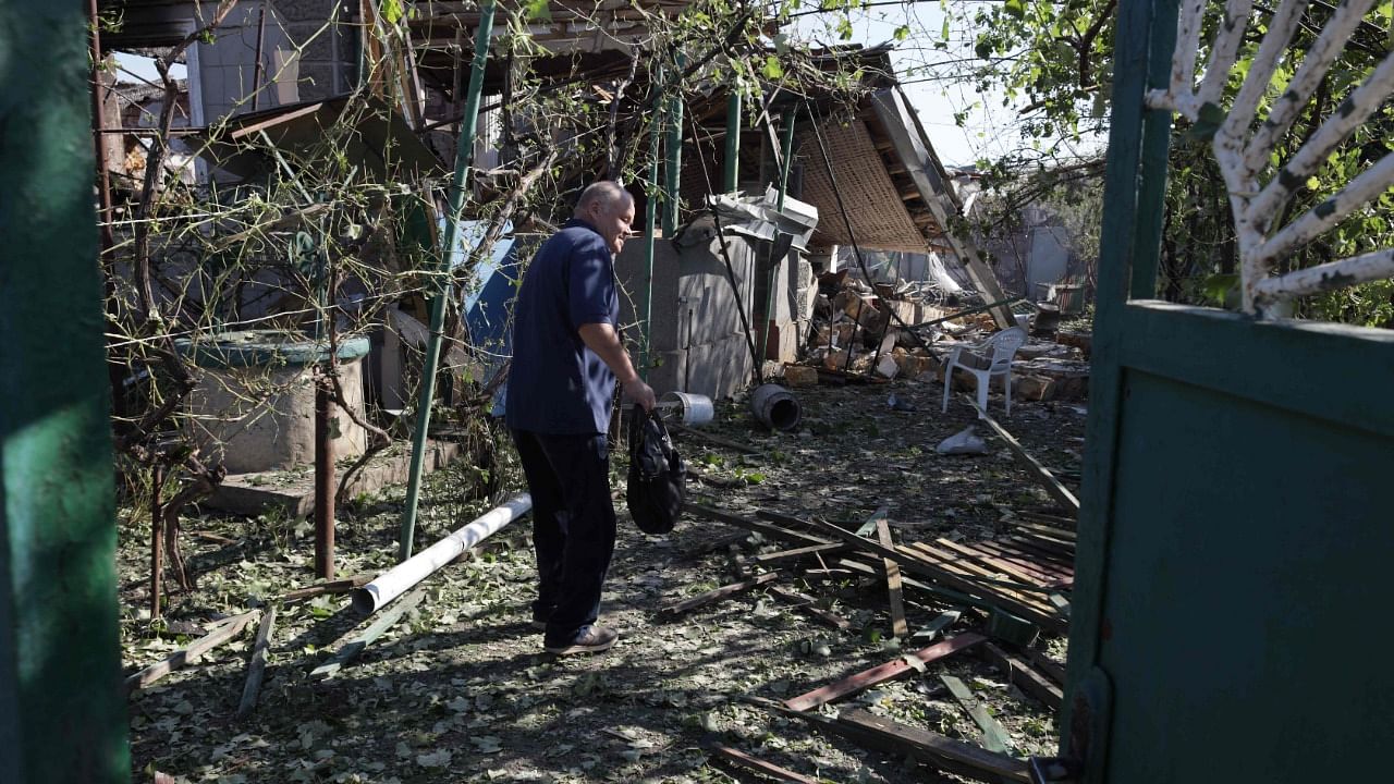 A man stands in a yard of his destroyed house following a Russian airstrike in a village in the Odessa region. Credit: AFP Photo