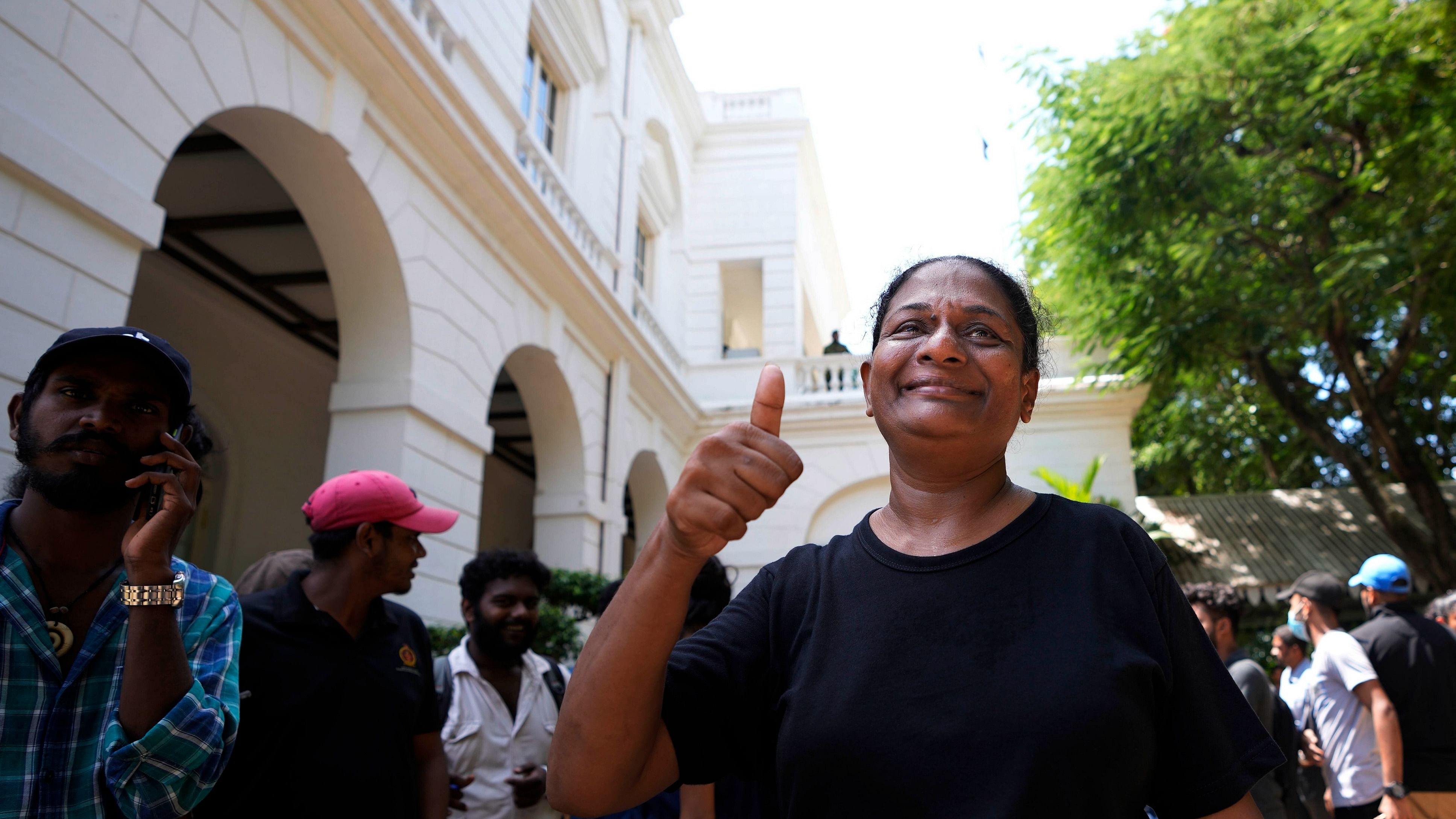 A protester displays the thumbs up as she vacates the presidential palace with other protesters in Colombo, Sri Lanka. Credit: AP/PTI Photo