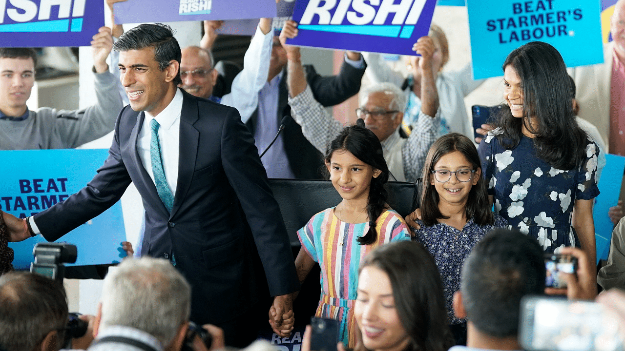 Former Treasury chief Rishi Sunak, left, arrives with with daughters Krishna, Anushka and wife Akshata Murthy. Credit: AP Photo