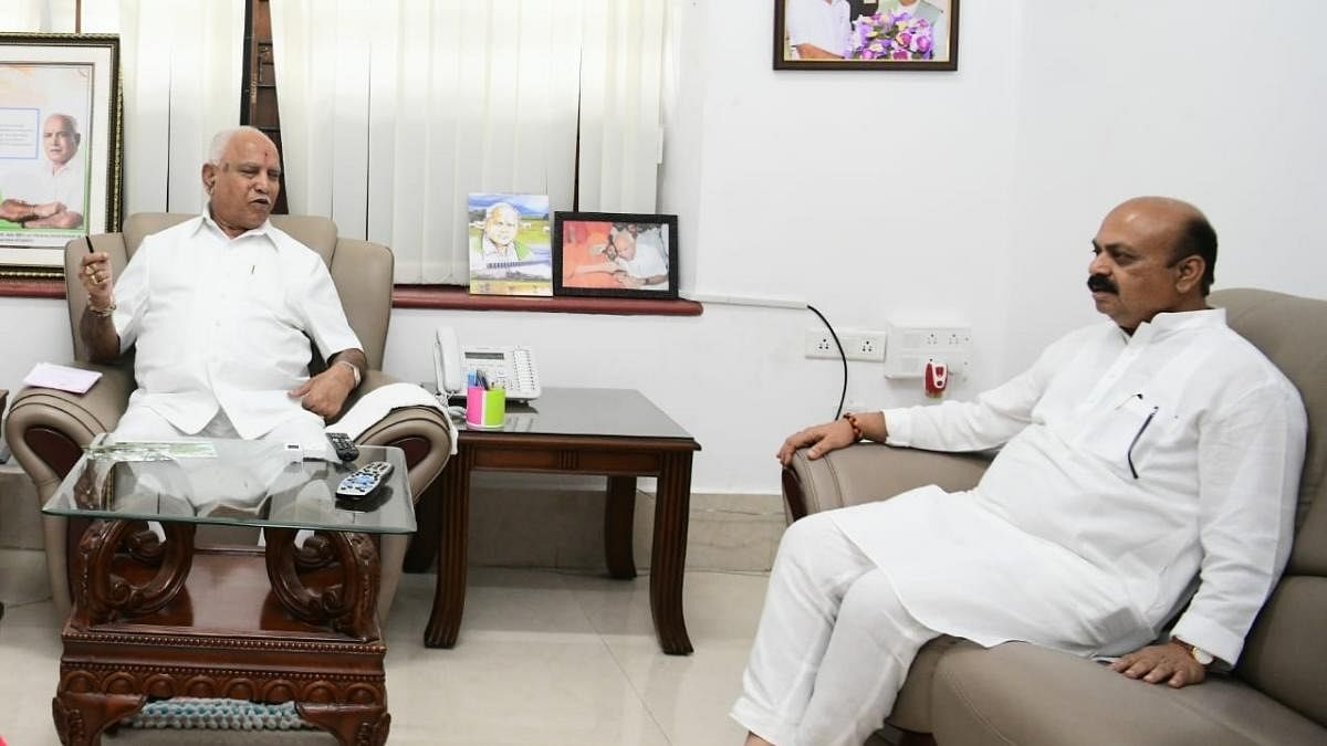 Chief Minister Basavaraj Bommai calls on his predecessor B S Yediyurappa at the latter's residence in Bengaluru on Saturday, a day after the party veteran announced to relinquish his Shikaripura Assembly seat in favour of his son B Y Vijayendra. Credit: DH Photo