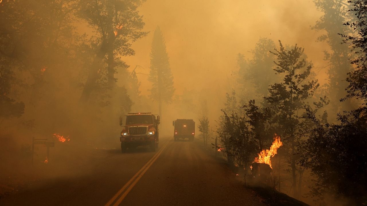 Cal Fire fire engines navigate Triangle Road as the Oak Fire moves through the area on July 23, 2022 near Mariposa, California. Credit: AFP Photo