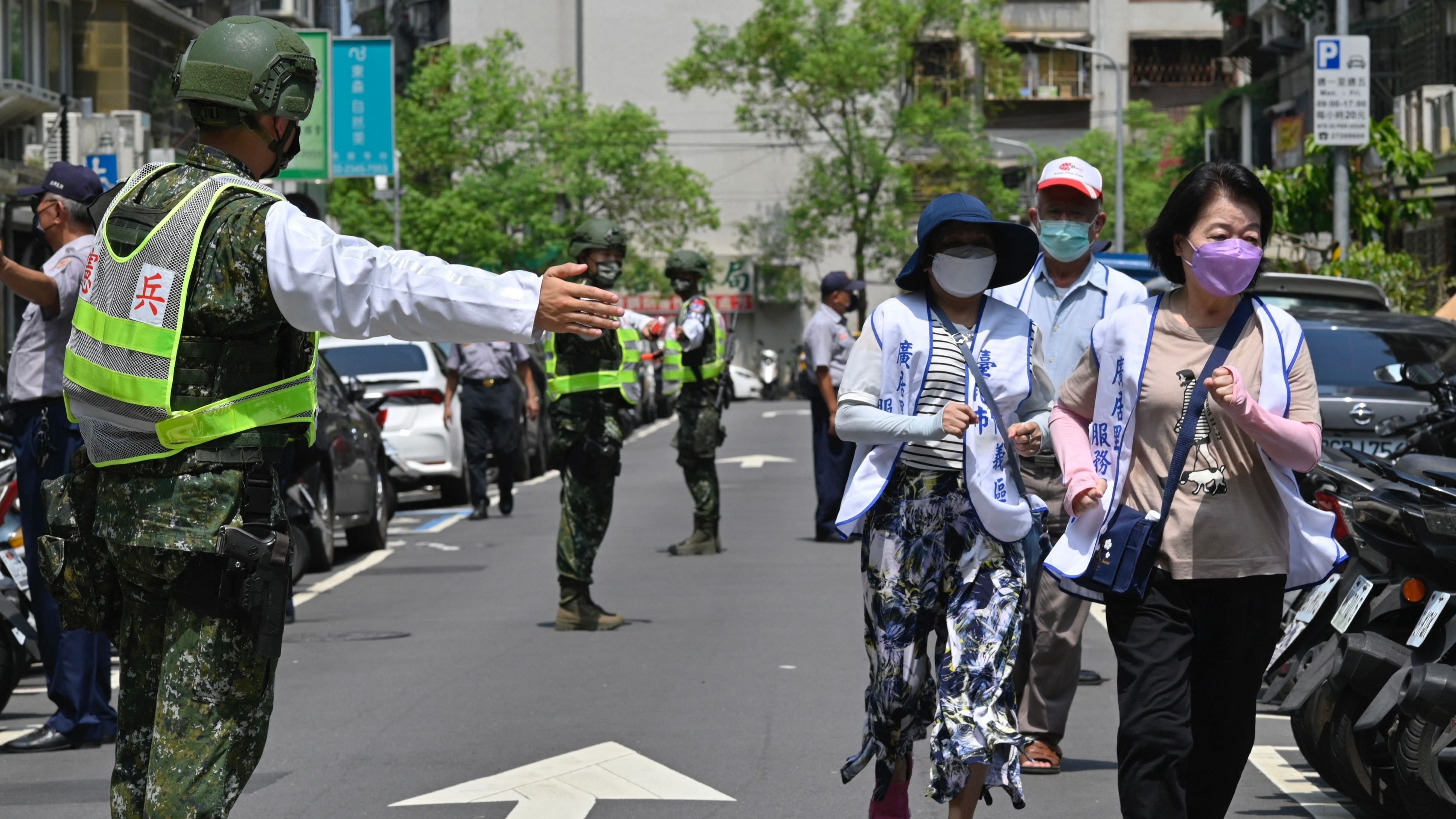 Military personnel guide local residents to take shelter during the Wanan Air Raid Drill. Credit: AFP Photo