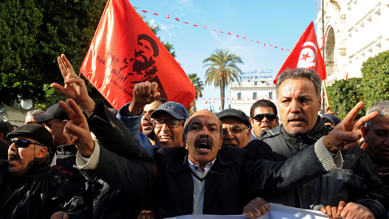 Tunisian workers shout slogans against the government in front of the Tunisian General Labour Union (UGTT) headquarters in Tunis as they mark the seventh anniversary since the uprising that launched the Arab Spring, on January 14, 2018. Credit: AFP File Photo