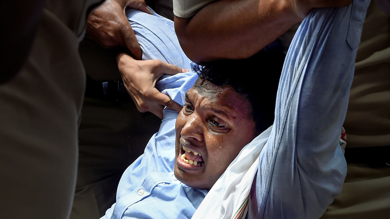 Police detain Youth Congress President Srinivas BV during a demonstration at the AICC office to express their solidarity with the party chief Sonia Gandhi, July 26, 2022. Credit: PTI Photo