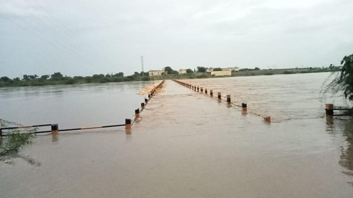 A bridge, which connects Sangavi (M) in Sedam of Kalaburagi district, has submerged in water following heavy rain. Credit: DH Photo