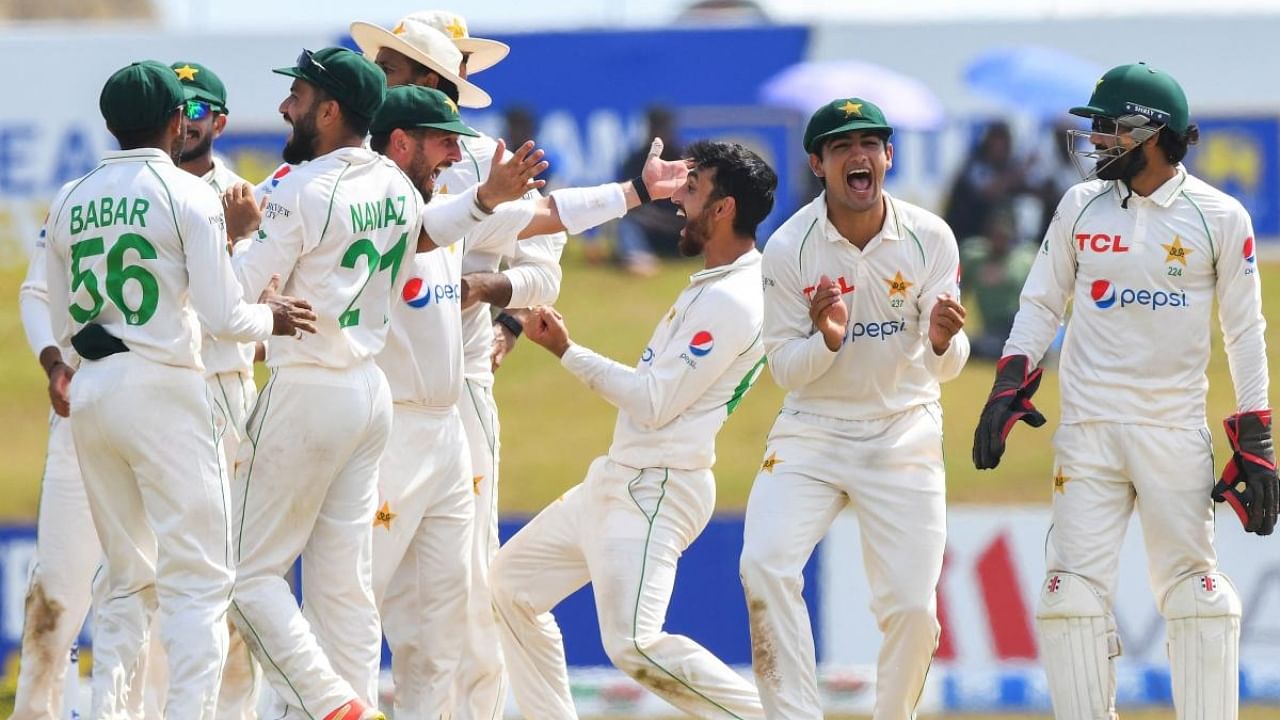 Pakistan’s Agha Salman (3R) celebrates with teammates after taking the wicket of Sri Lanka's Angelo Mathews (not pictured) during the third day of play of the second cricket Test match between Sri Lanka and Pakistan at the Galle International Cricket Stadium in Galle on July 26, 2022. Credit: AFP Photo