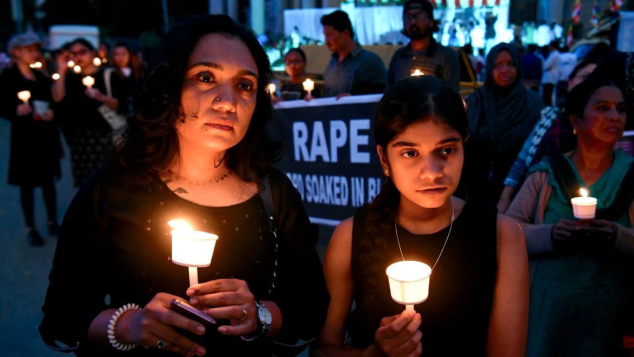 People hold a candlelight vigil in support of sexual assault victims. Credit: PTI Photo