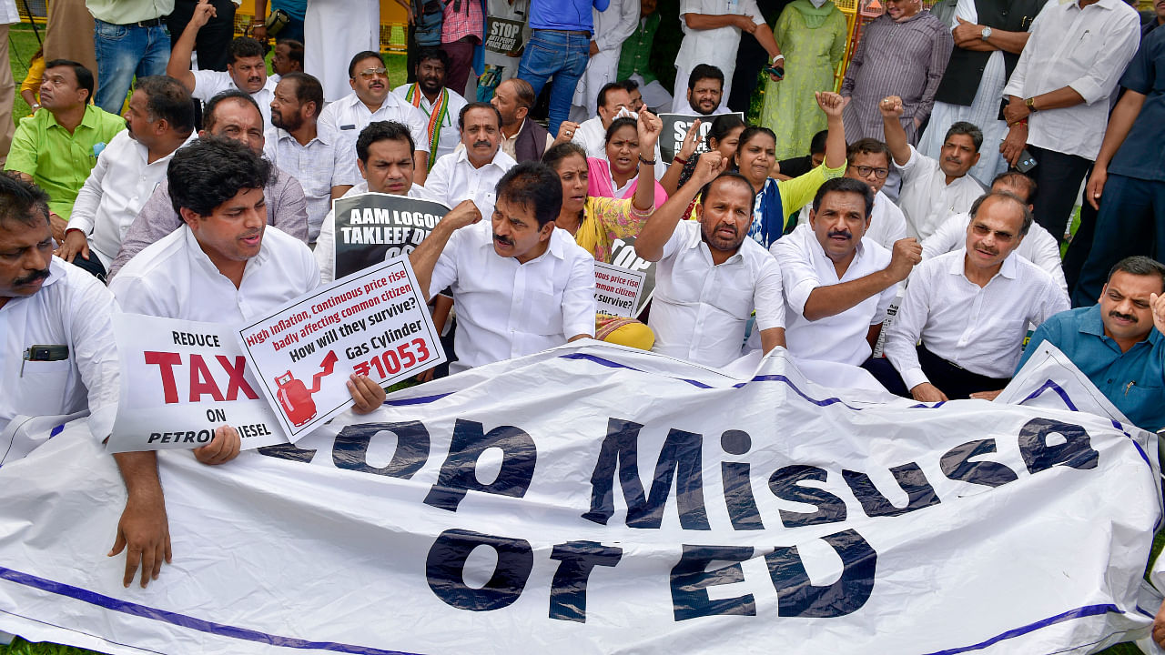 Congress MPs holding a banner shout slogans during their protest at Vijay Chowk against alleged misuse of ED and price rise, in New Delhi, Wednesday, July 27, 2022. Credit: PTI Photo