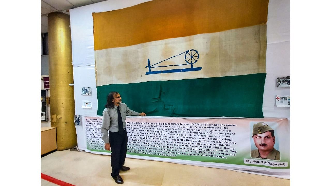 Dev Nagar, the grandson of Maj Gen G R Nagar, at the college where the 9X14 foot khadi Tricolour, with the image of a full charkha, was displayed for public viewing, at the Pimpri Chinchwad in Pune, Tuesday, July 26, 2022. Credit: PTI Photo