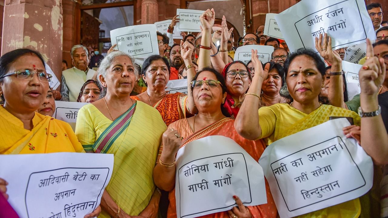 Union Finance Minister Nirmala Sitharaman with other BJP MPs during a protest against Congress leader Adhir Ranjan Chowdhury's remarks on President Droupadi Murmu, at Parliament House. Credit: PTI Photo