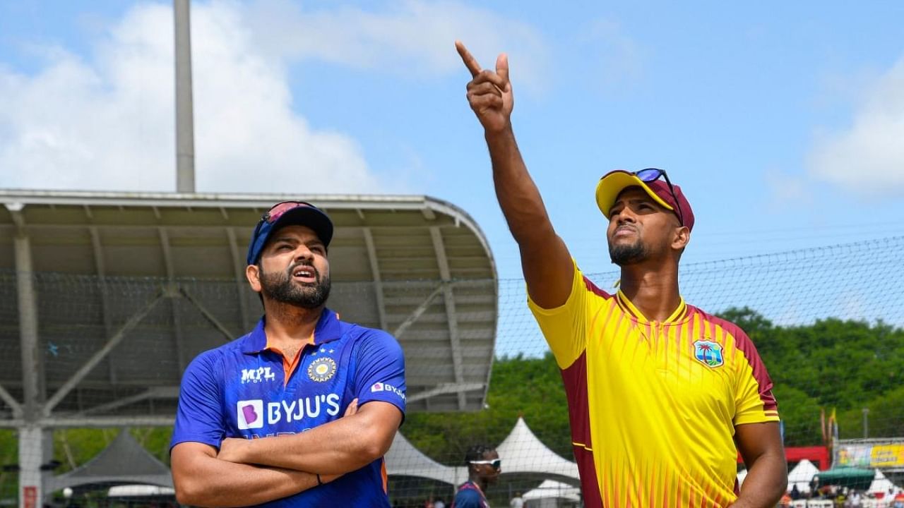 Nicholas Pooran (R) of West Indies tosses the coin as Rohit Sharma (L) of India watches during the 1st T20i match between West Indies and India at Brian Lara Cricket Academy in Tarouba, Trinidad and Tobago on July 29, 2022. Credit: AFP Photo