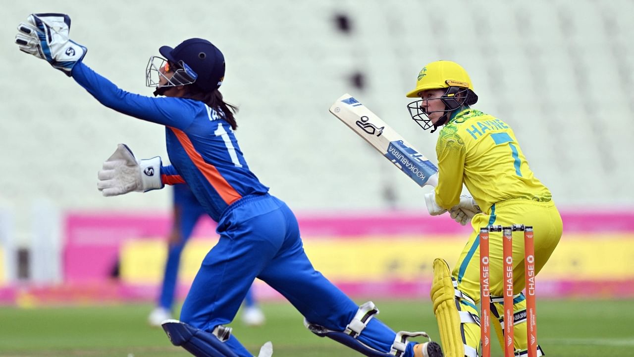 Australia's Rachael Haynes (R) wtaches as India's Yastika Bhatia attempts to catch the ball during the women's Twenty20 cricket match between Australia and India on day one of the Commonwealth Games at Edgbaston. Credit: AFP Photo