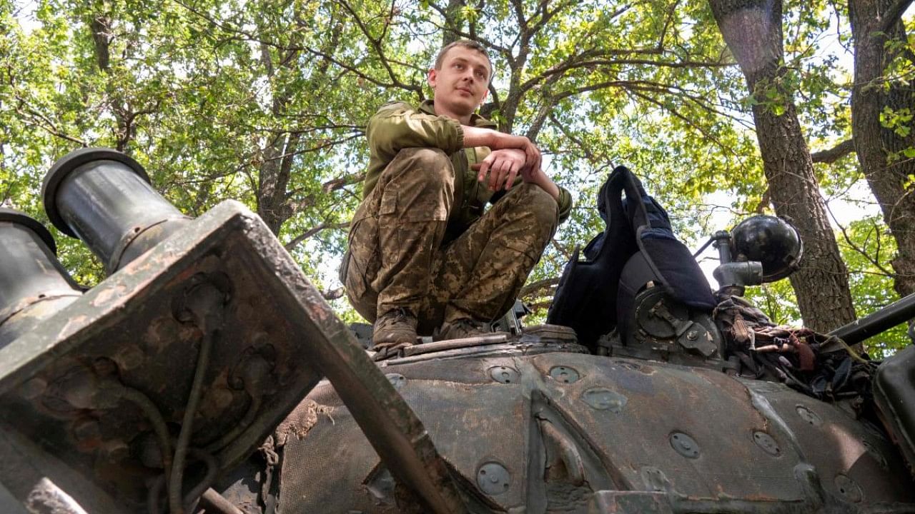 A Ukrainian soldier stands on a tank near Kharkiv. Credit: AFP File Photo