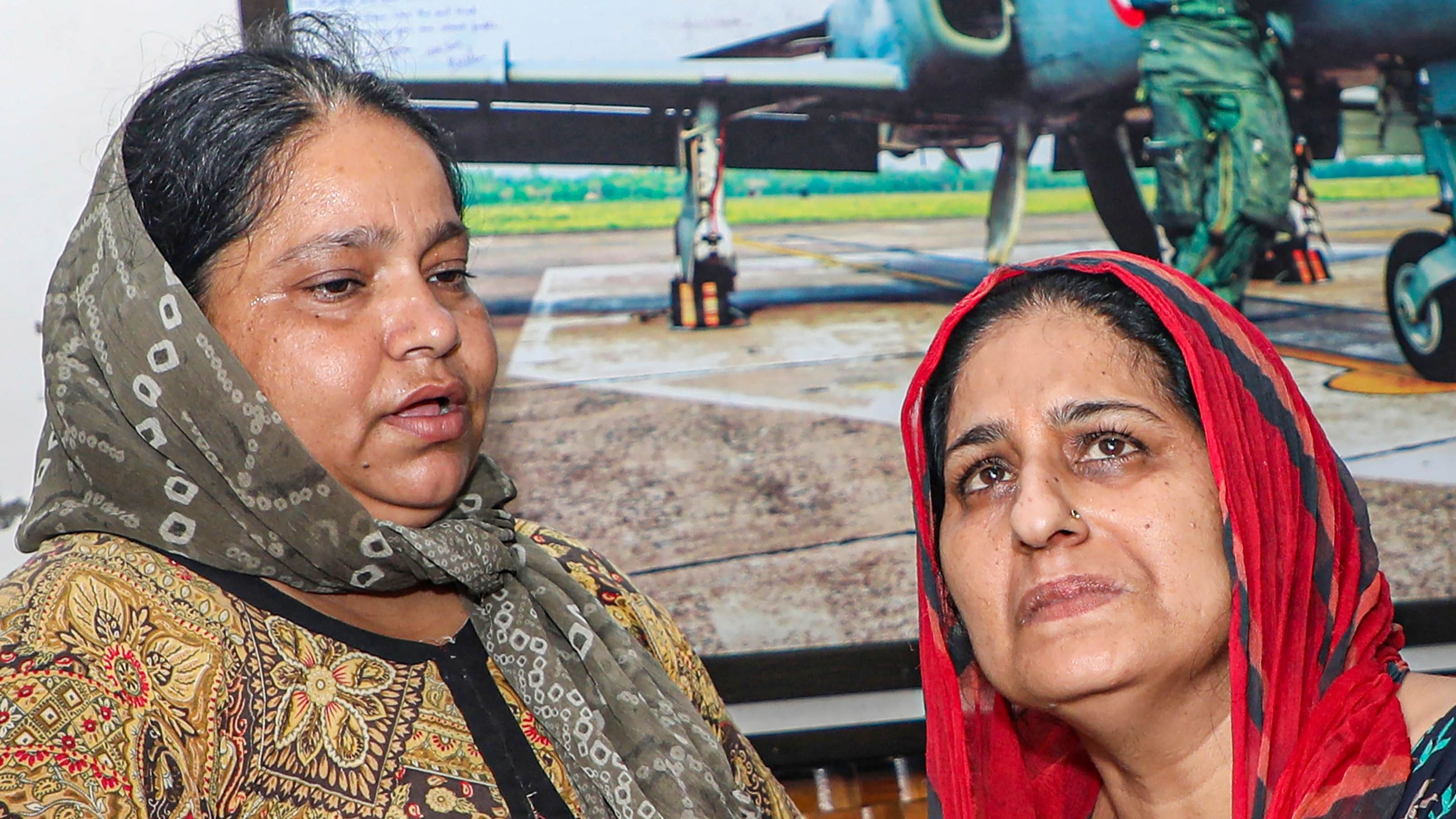 Family members of Flight Lieutenant Advitiya Bal react as they wait for his mortal remains, at his residence in Jammu, Friday, July 29, 2022. Bal along with another pilot was killed in Thursday night's crash of a MiG-21 trainer aircraft of the Indian Air Force in Rajasthan's Barmer. Credit: PTI Photo