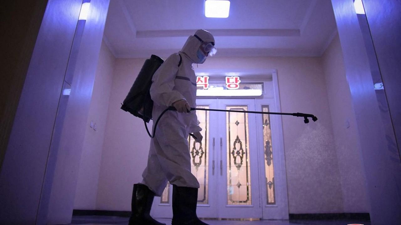 This undated picture and released from North Korea's official Korean Central News Agency (KCNA) on July 2, 2022 shows a staff member disinfecting the facility to prevent the spread of the Covid-19 coronavirus in a hotel of Pyongyang. Credit: AFP Photo