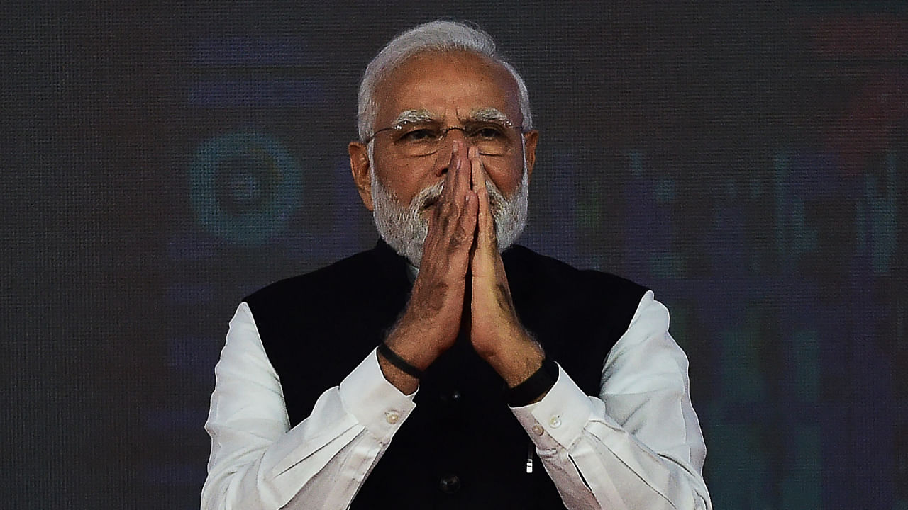 PM Modi gestures during the launch of the India International Bullion Exchange and the NSE IFSC-SGX Connect at the GIFT City near Gandhinagar on July 29, 2022. Credit: AFP Photo