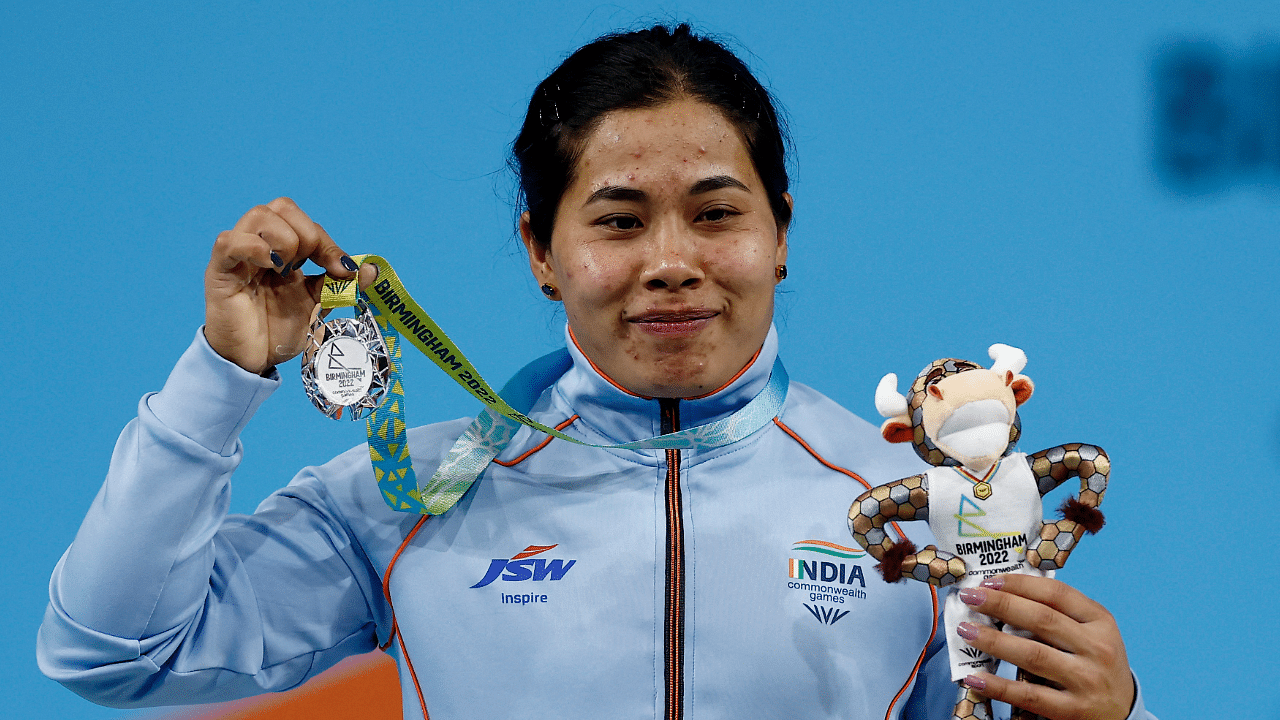 Silver medallist India's Bindyarani Devi Sorokhaibam celebrates on the podium. Credit: Reuters Photo