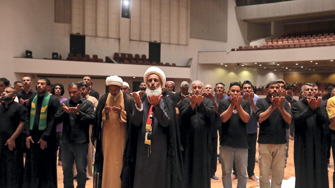 Followers of Shiite cleric Muqtada al-Sadr pray during a sit-in, inside the parliament in Baghdad, Iraq. Credit: AP/PTI