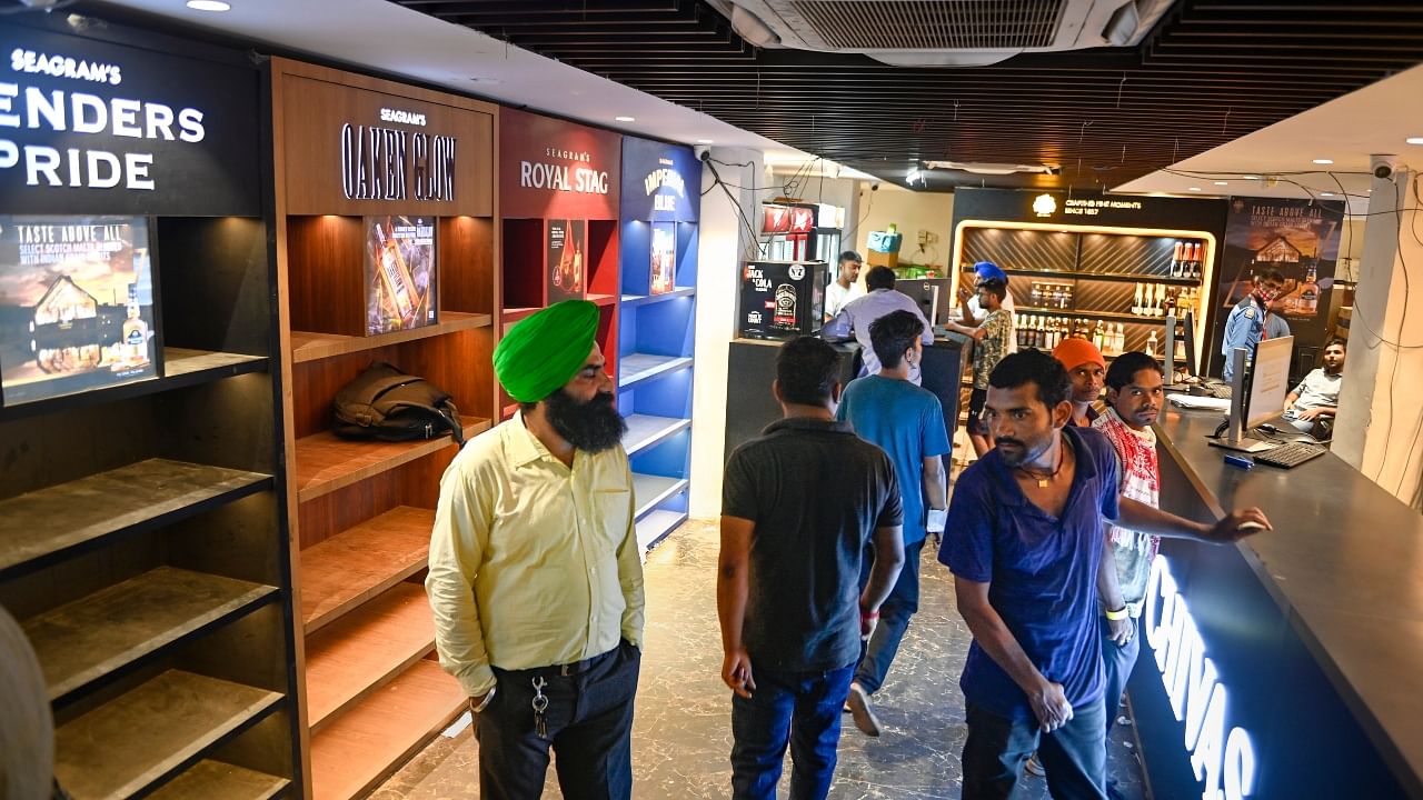 Customers at a wine shop in Connaught Place in New Delhi. Credit: PTI Photo
