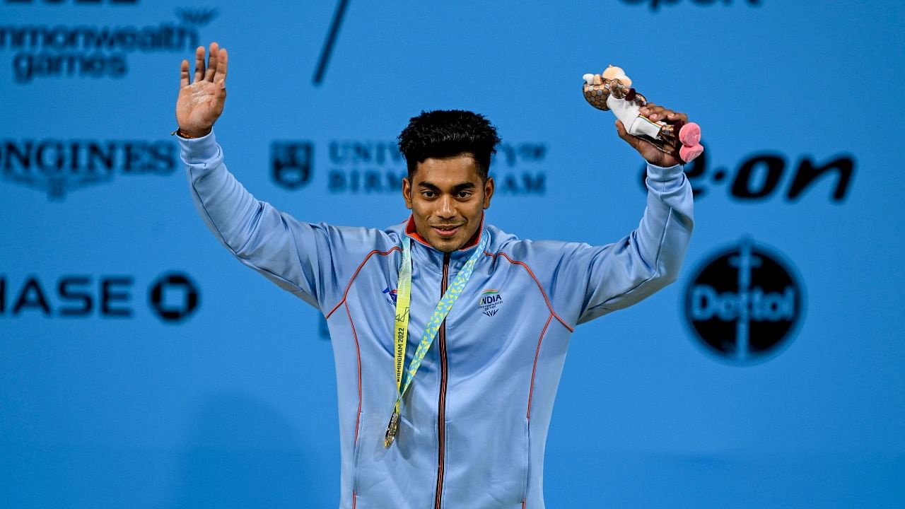 India's Achinta Sheuli with the gold medal after winning the men's 73kg weightlifting category match of the Commonwealth Games 2022 (CWG), in Birmingham. Credit: PTI Photo