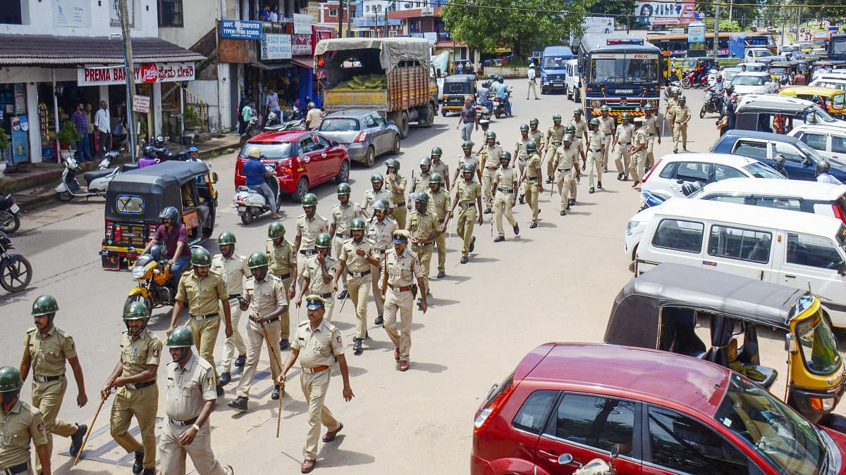 Police personnel conduct a march past in Puttur, Mangaluru. Credit: PTI Photo