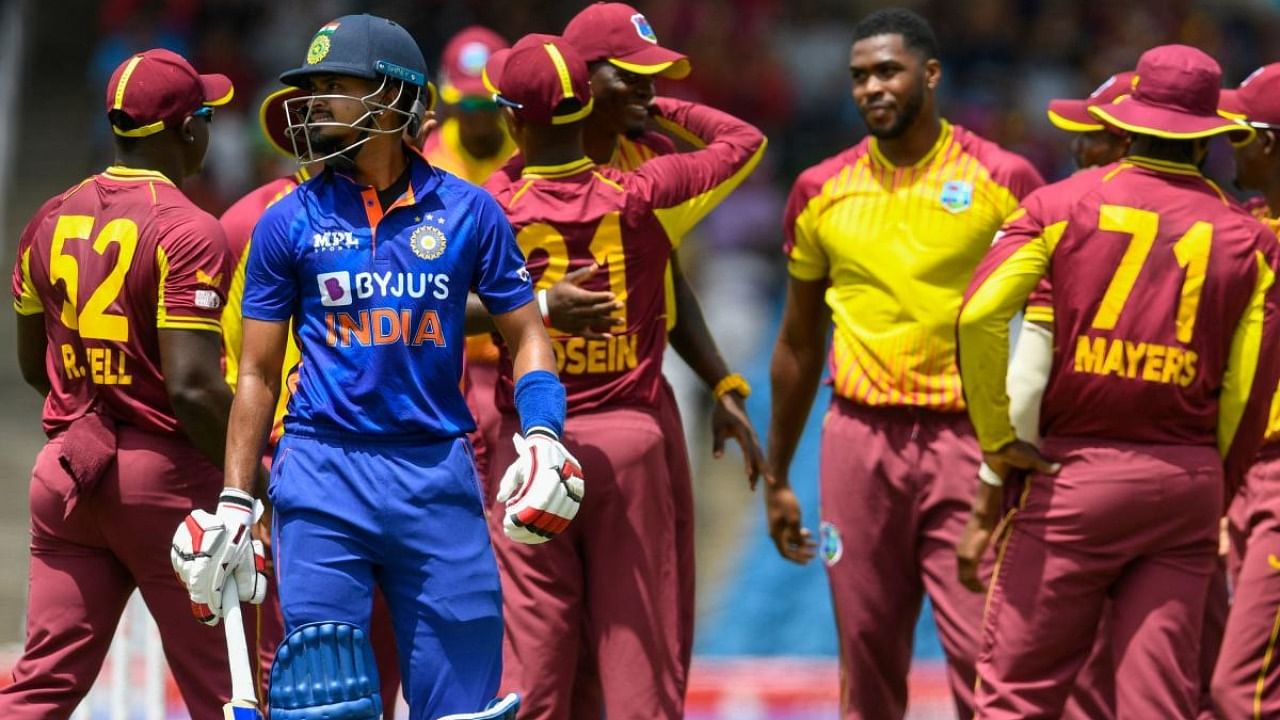 Obed McCoy (R), Odean Smith (L), Brandon King (2L), and Jason Holder (3L), of West Indies, celebrate the dismissal of Rohit Sharma, of India, during the second T20I match between West Indies and India at Warner Park in Basseterre. Credit: AFP Photo