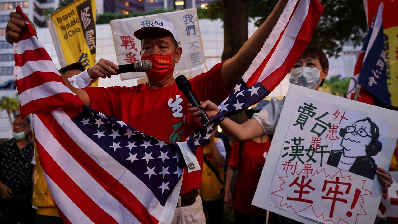 A demonstrator tears a US flag during a protest against US House of Representatives Speaker Nancy Pelosi's visit, in Taipei. Credit: Reuters photo