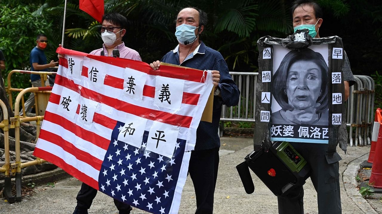 Pro-Beijing protesters hold an image depicting the US House Speaker Nancy Pelosi and the US flag at a protest outside the US Consulate in Hong Kong. Credit: AFP Photo