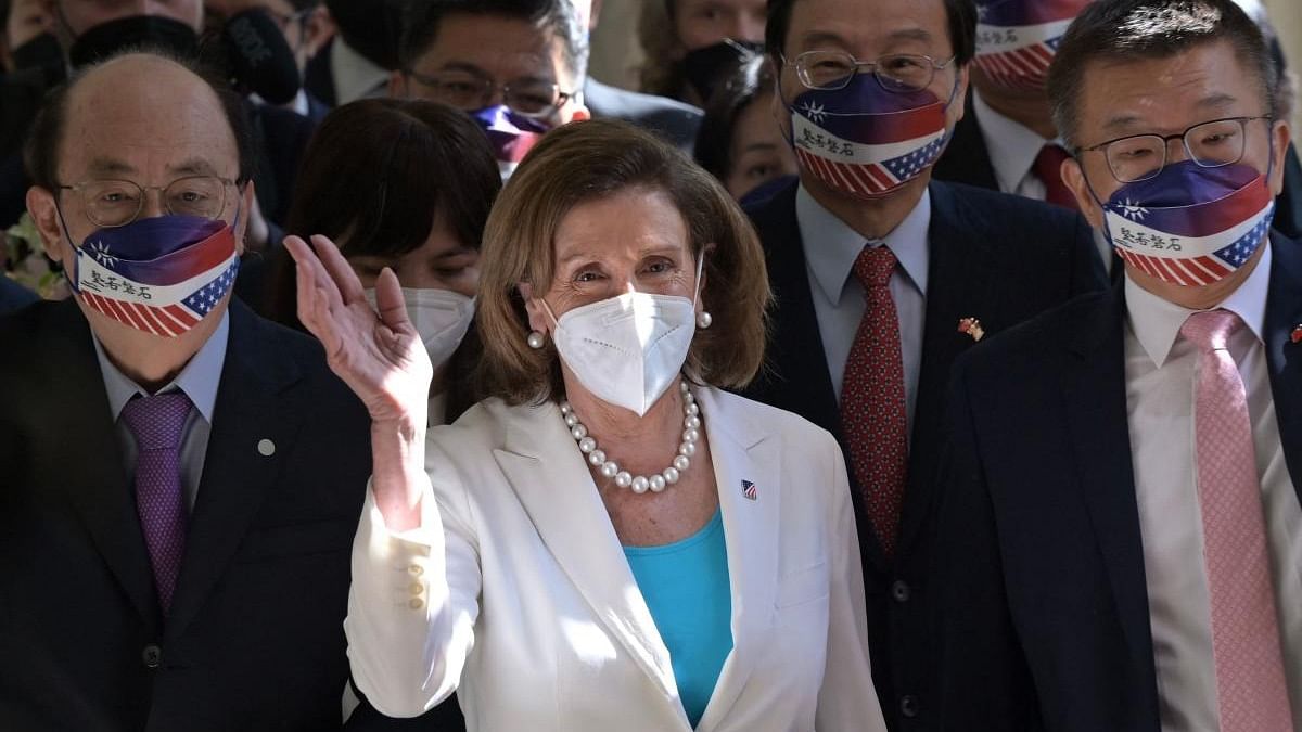 Visiting US House Speaker Nancy Pelosi waves to journalists during her arrival at the Parliament in Taipei. Credit: AFP Photo