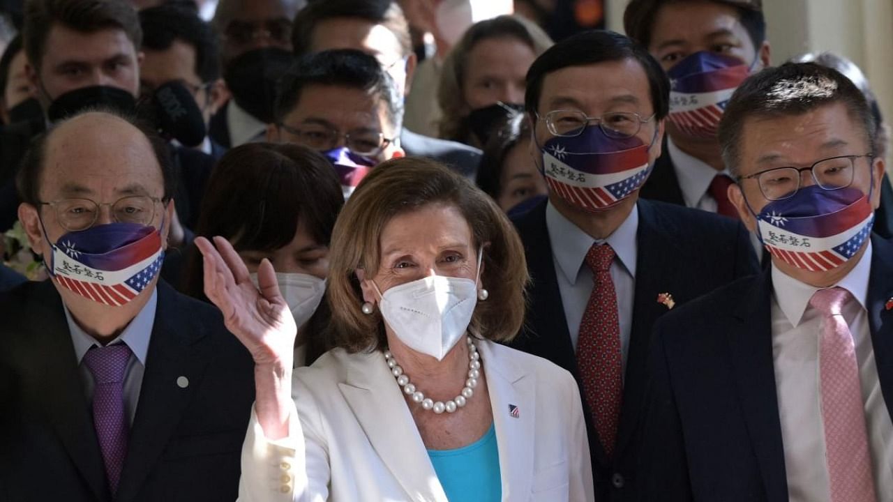 Visiting US House Speaker Nancy Pelosi (C) waves to journalists during her arrival at the Parliament in Taipei on August 3, 2022. Credit: AFP Photo