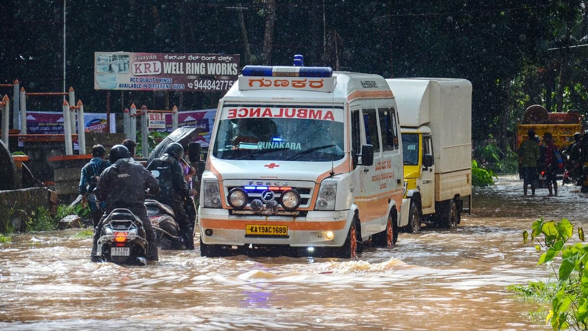 An ambulance passes through a waterlogged road following monsoon rains, in Mangaluru. Credit: PTI Photo