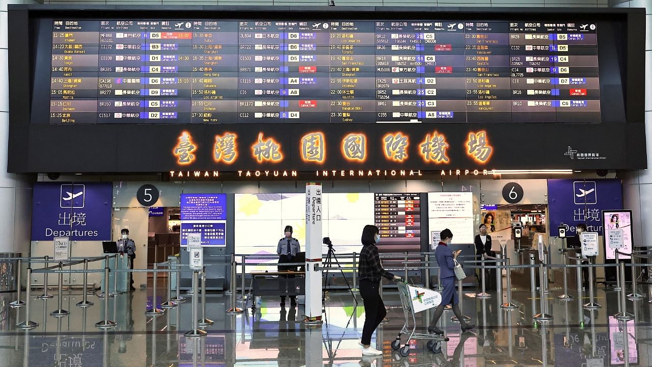 People walk past the departure gate at Taoyuan International Airport in Taoyuan, Taiwan. Credit: Reuters Photo