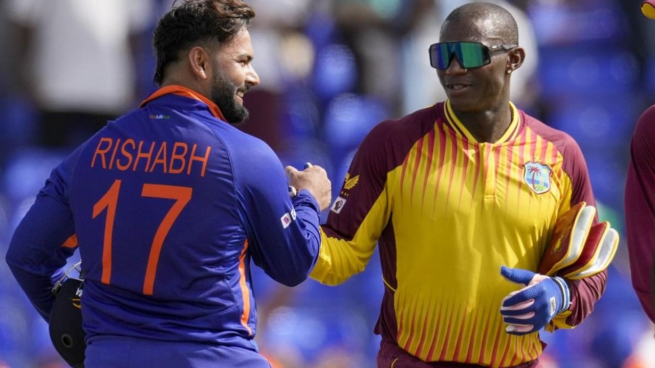 India's Rishabh Pant shakes hands with West Indies' wicketkeeper Devon Thomas. Credit: AP Photo