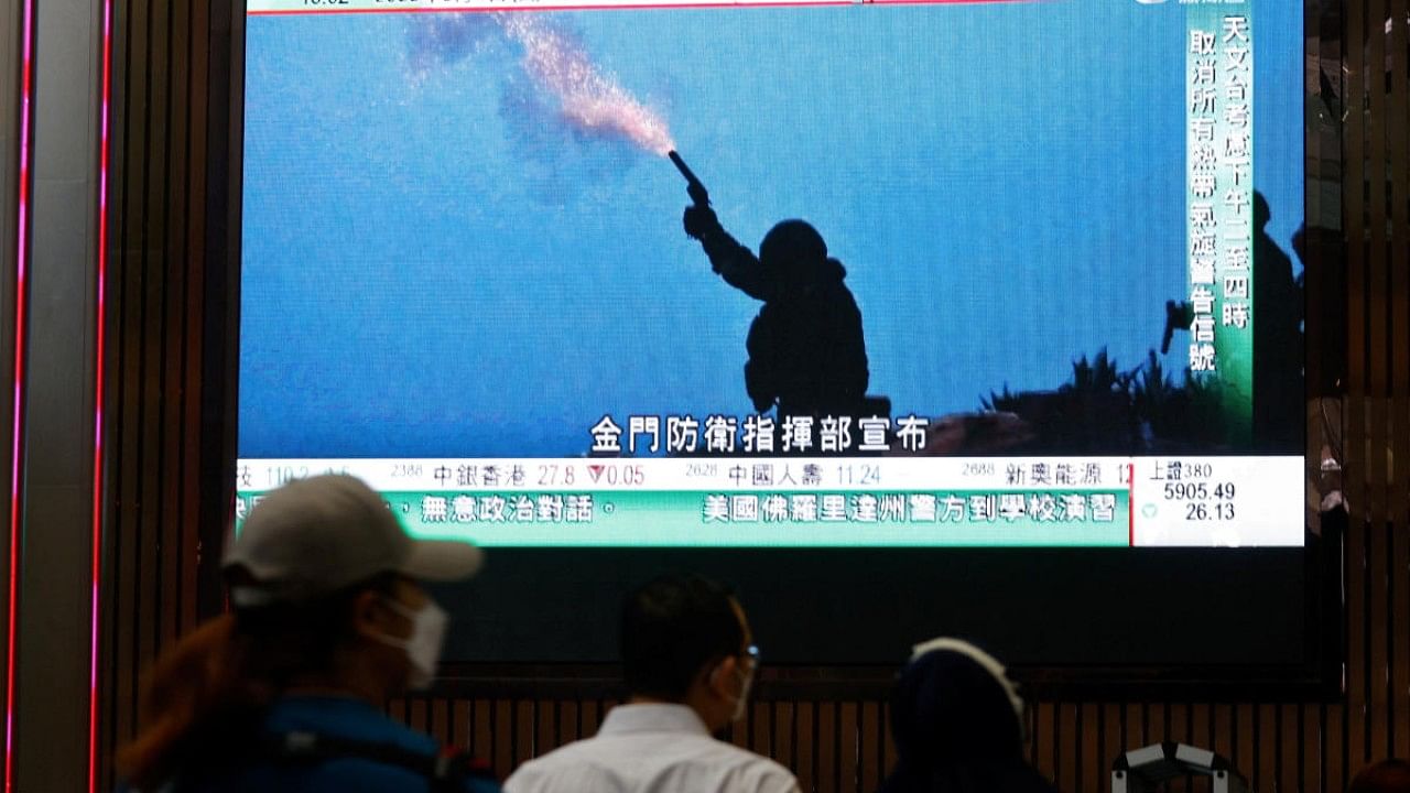 A TV screen shows that China's People's Liberation Army has begun military exercises including live firing on the waters and in the airspace surrounding the island of Taiwan, in Hong Kong. Credit: Reuters Photo