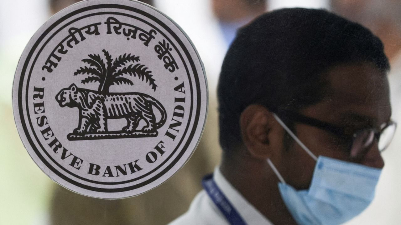 A man walks past the logo of Reserve Bank of India (RBI) inside its headquarters in Mumbai. Credit: Reuters Photo