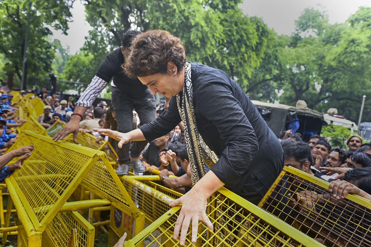 Congress leader Priyanka Gandhi, wearing black clothes, during a protest march as part of party’s nationwide protest over price rise, unemployment and GST hike on essential items, in New Delhi, Friday, Aug. 5, 2022. Credit: PTI Photo