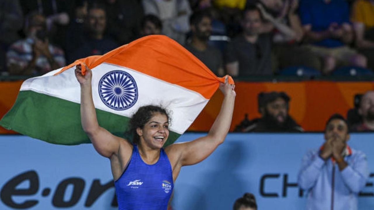 Sakshi Malik holds the tricolor after winning against Canada's Ana Godinez Gonzalez in the final of the Women's Freestyle Wrestling 62kg category event, at the Commonwealth Games 2022 (CWG), in Birmingham, UK, Friday, Aug. 5, 2022. Malik won the gold medal. Credit: PTI Photo