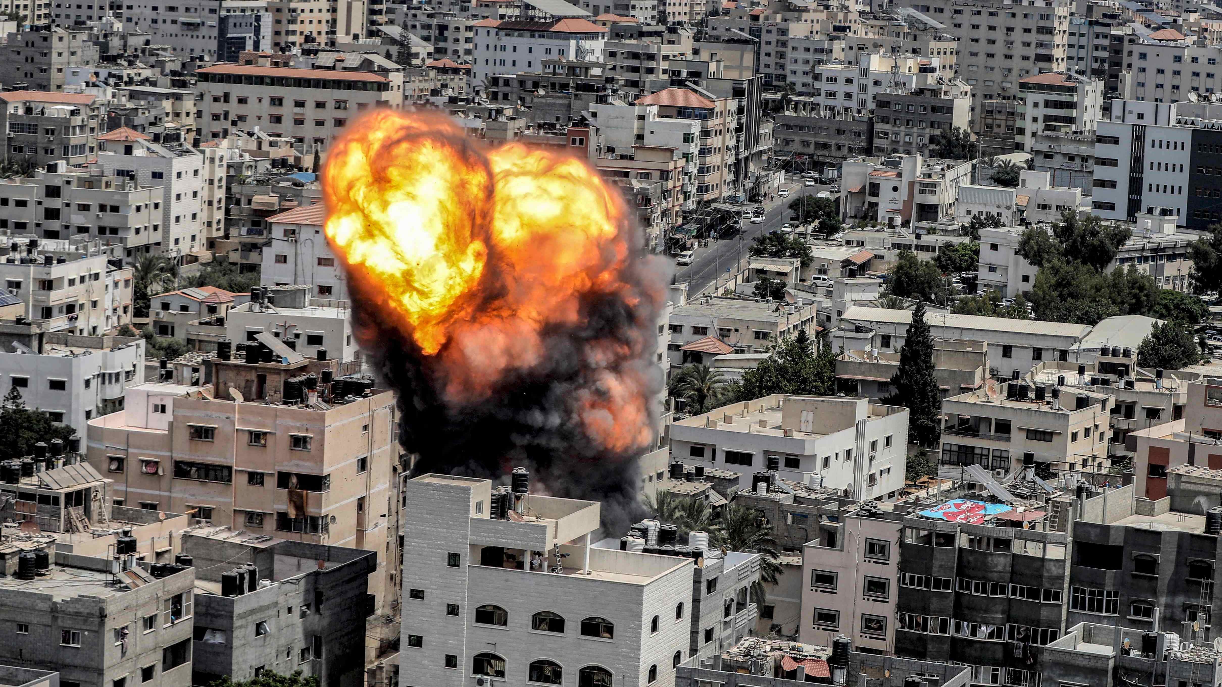 A fireball erupts as a result of an Israeli air strike on a building in Gaza City. Credit: AFP Photo