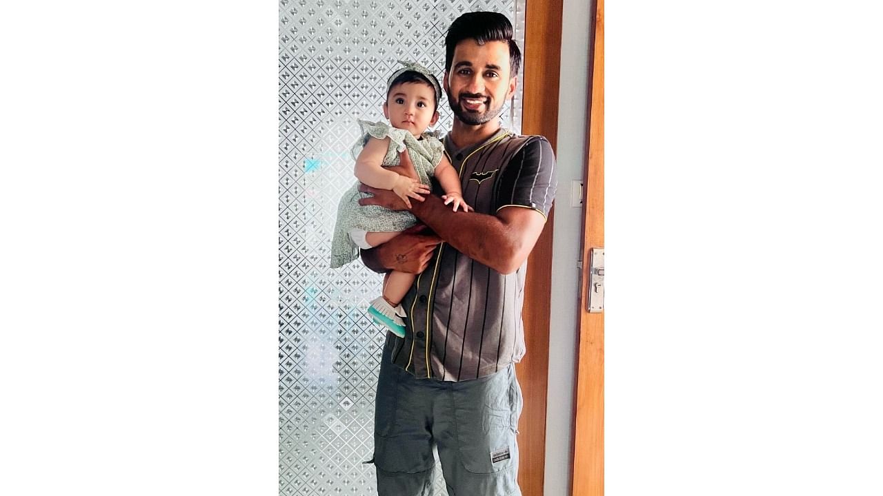 Indian men's hockey team skipper Manpreet with his eight-month-old daughter. Credit: IANS Photo