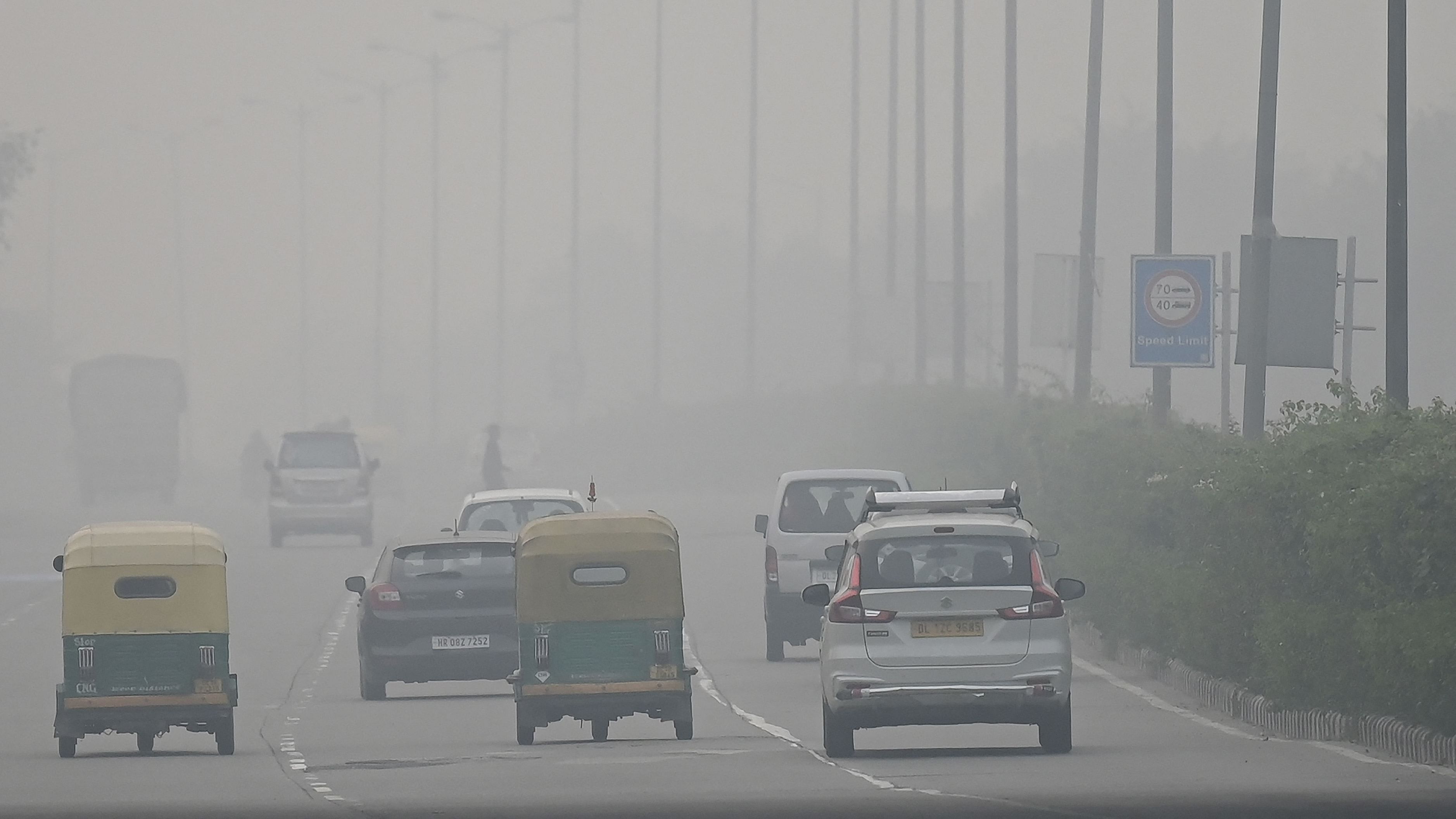 Commuters make their way along a road amid smoggy conditions in New Delhi on 21 Nov, 2021. Credit: AFP File Photo 