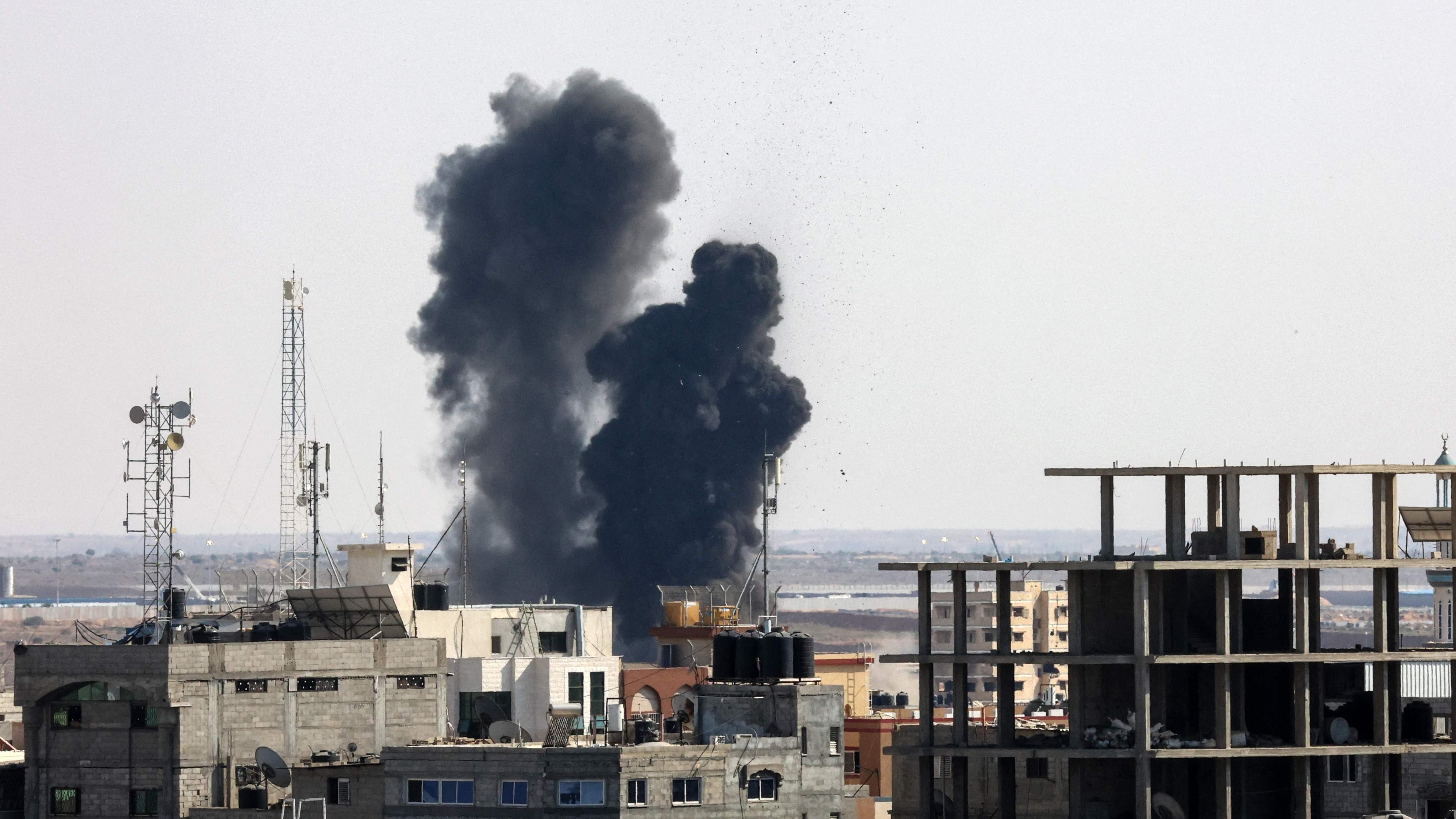 Smoke billows from a building struck during an Israeli air strike in Rafah in the southern Gaza Strip. Credit: AFP Photo