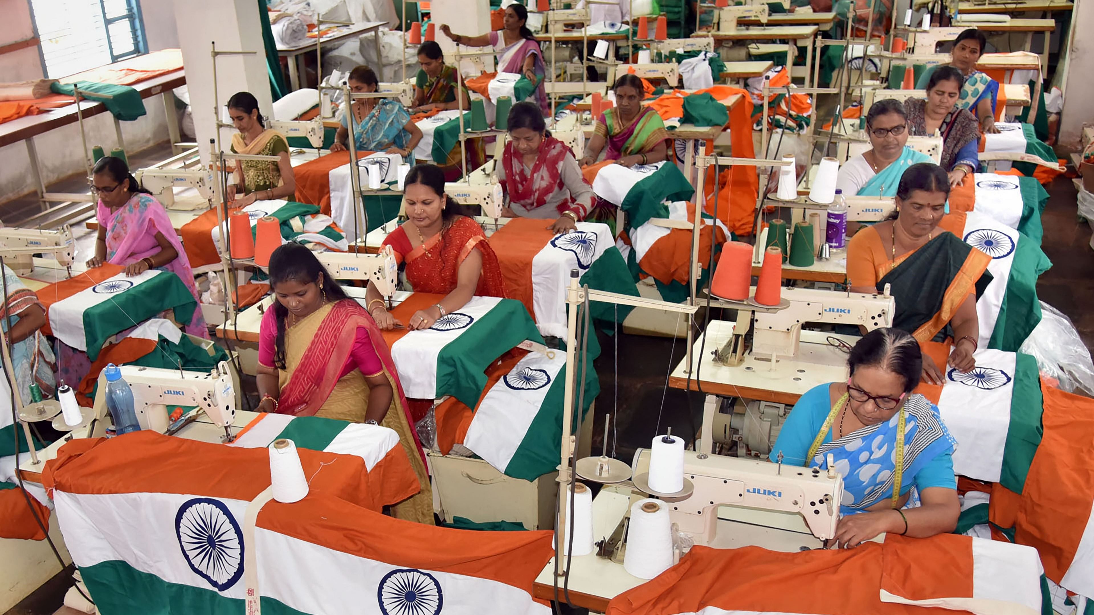 Workers prepare Indian national flags ahead of the 75th Independence Day celebrations, at the Karnataka Khadi Gramodyoga Samyukta Sangha (KKGSS), the only unit in India that is authorised to manufacture and supply the Indian flag. Credit: PTI File Photo