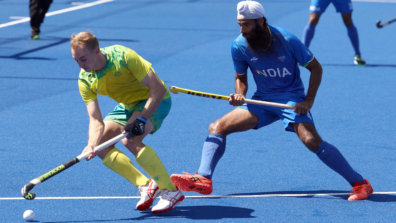 Australia's Jacob Anderson (left) vies with India's Jarmanpreet Singh (right) during the CWG men's gold medal hockey match between Australia and India, August 8, 2022. Credit: AFP Photo