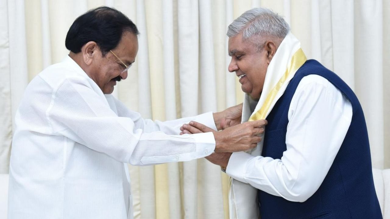 Vice President M. Venkaiah Naidu felicitates Vice President-elect Jagdeep Dhankhar during their meeting at Upa-Rashtrapati Nivas, in New Delhi. Credit: PTI Photo