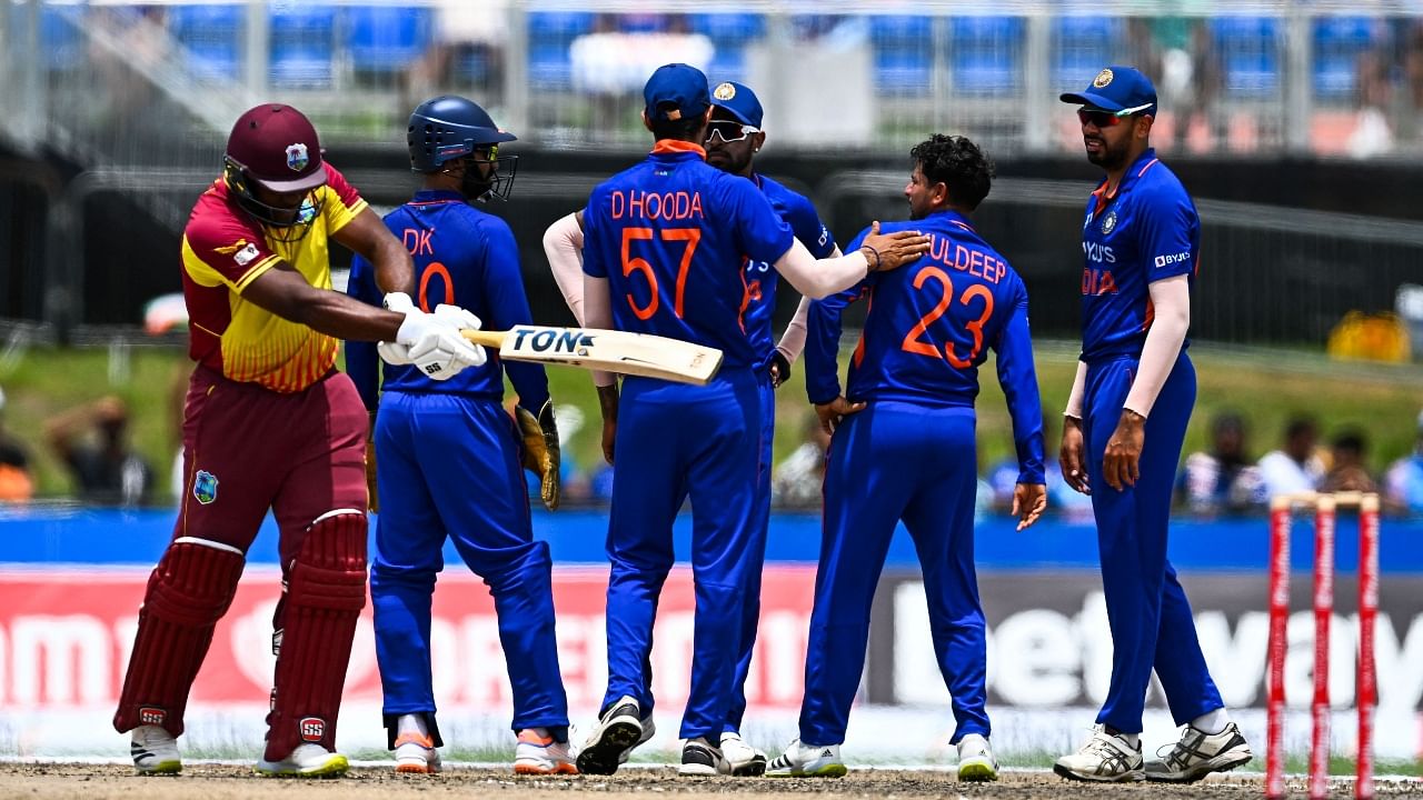 Odean Smith, of West Indies (L), walks back after getting dismissed by Kuldeep Yadav, of India (2R), during the fifth and final T20I match between West Indies and India at the Central Broward Regional Park in Lauderhill, Florida. Credit: AFP Photo
