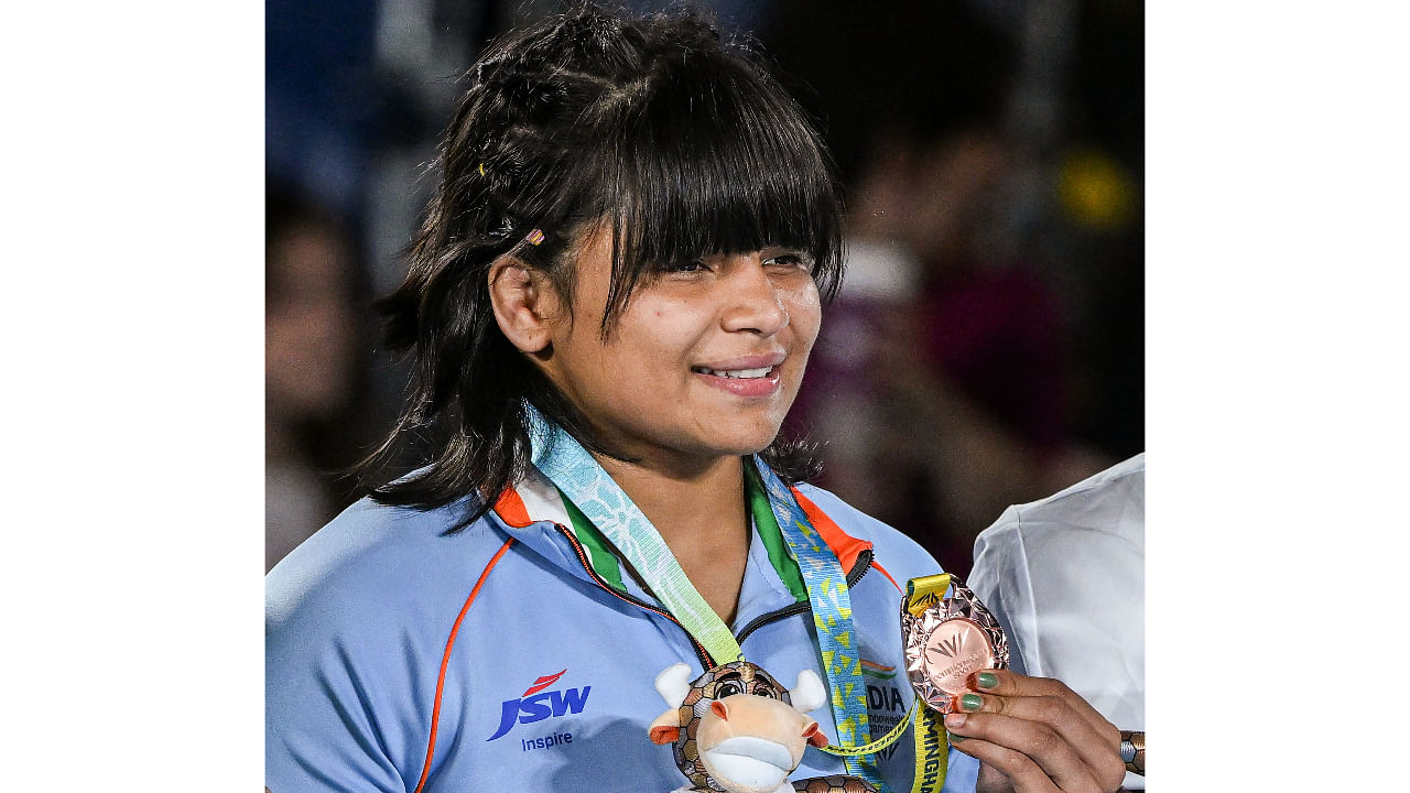 Bronze medallist Divya Kakran poses for photographs during the Women's Freestyle Wrestling 68kg event, at Commonwealth Games 2022. Credit: PTI Photo