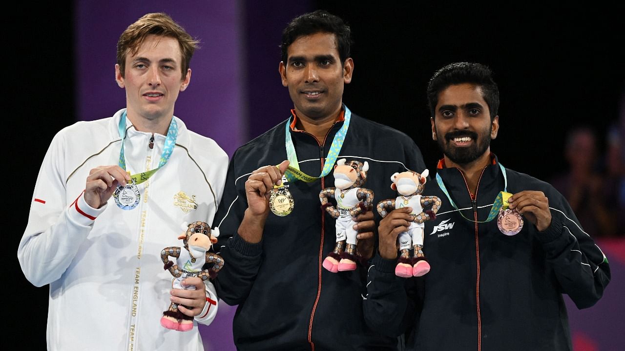 England's Liam Pitchford (L), Sharath Kamal Achanta (C) and India's Sathiyan Gnanasekaran pose during a medal presentation ceremony for the men's singles table tennis event on day eleven of the Commonwealth Games. Credit: AFP Photo