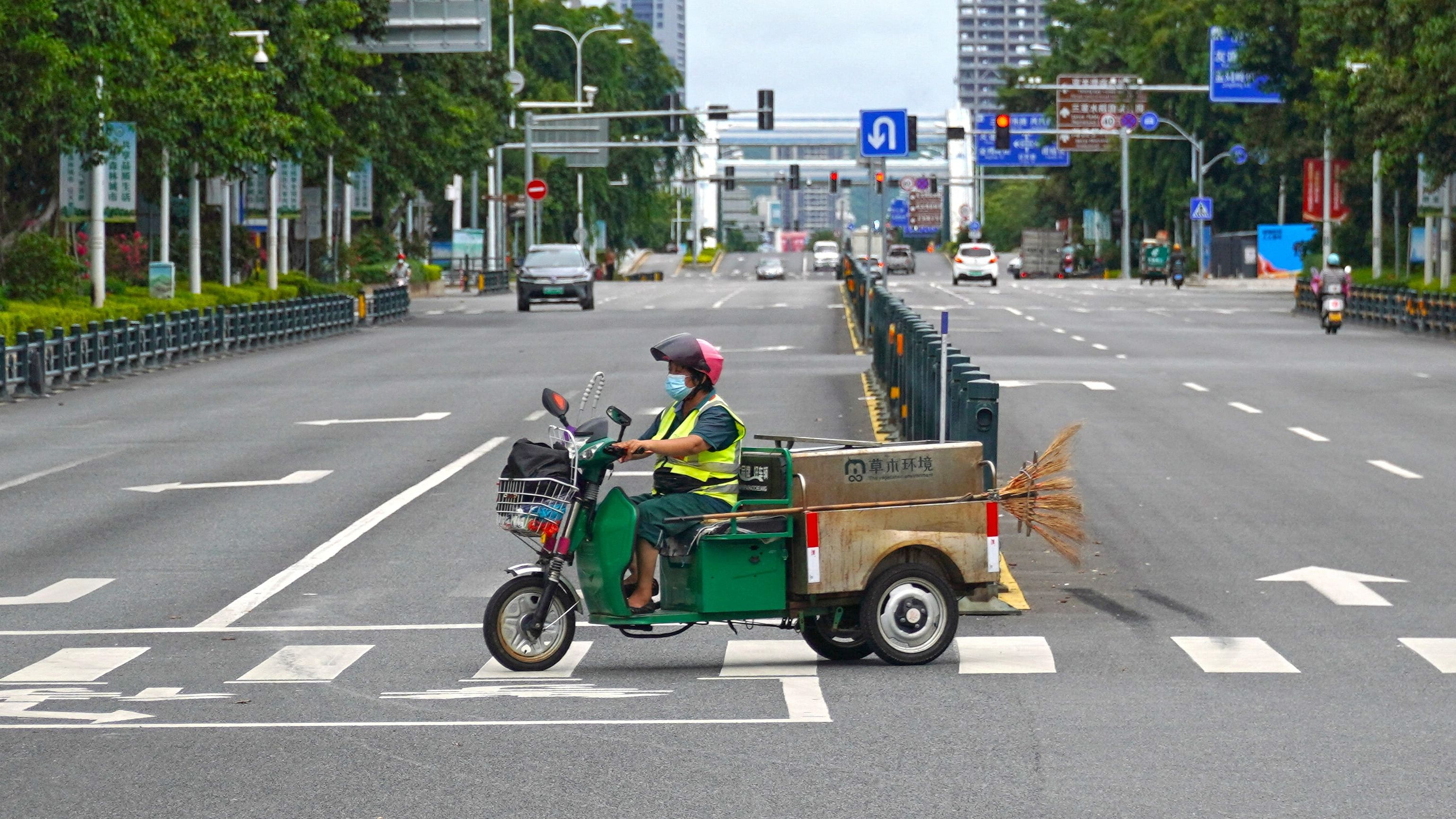 A sanitation worker drives past an intersection amid lockdown measures to curb the coronavirus disease (Covid-19) outbreak in Sanya, Hainan province, China. Credit: Reuters Photo