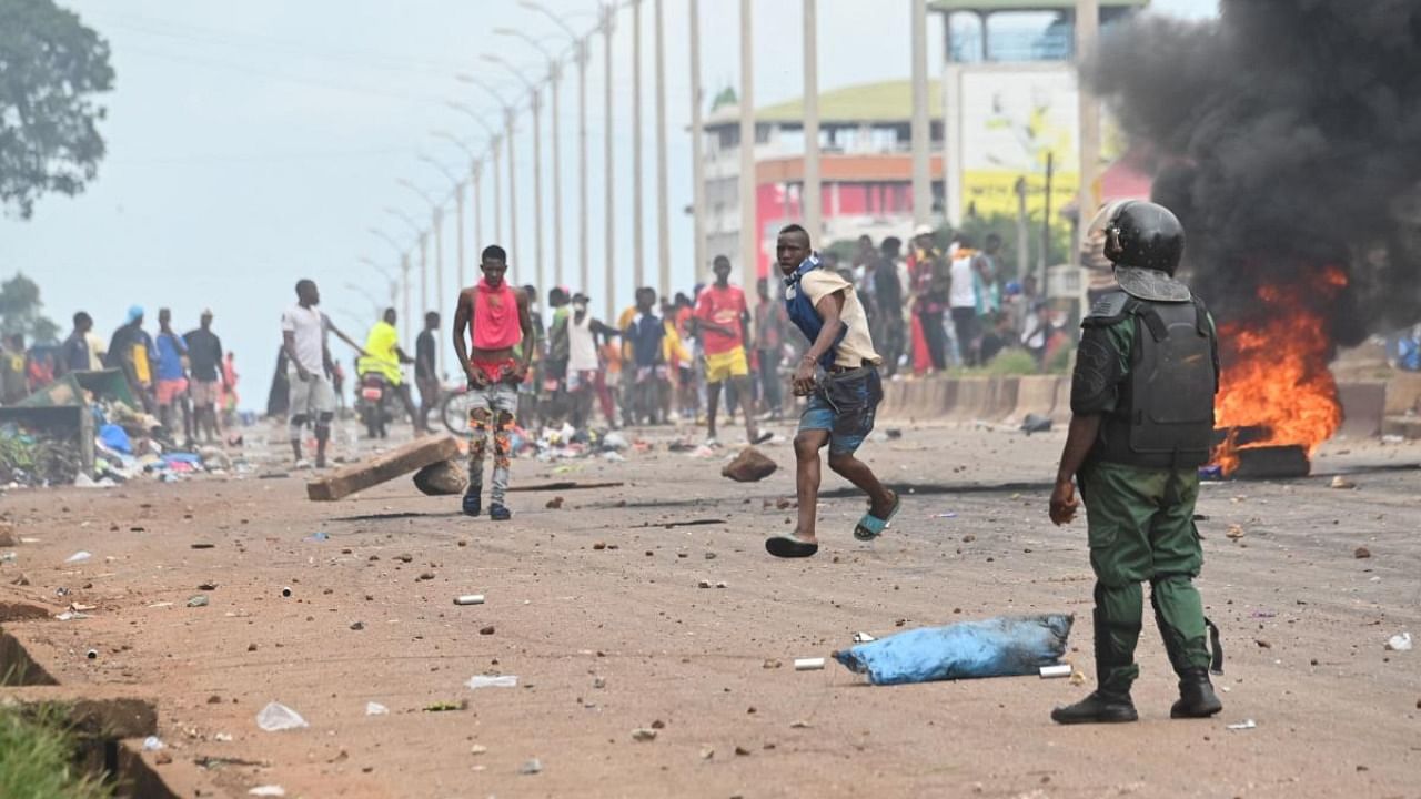 A police officer looks on as protesters block roads and hurl rocks in Conakry after authorities prevented supporters of the opposition party, National Front for the Defence of the Constitution (FNDC), from gathering in the streets for a peaceful march. Credit: AFP file photo