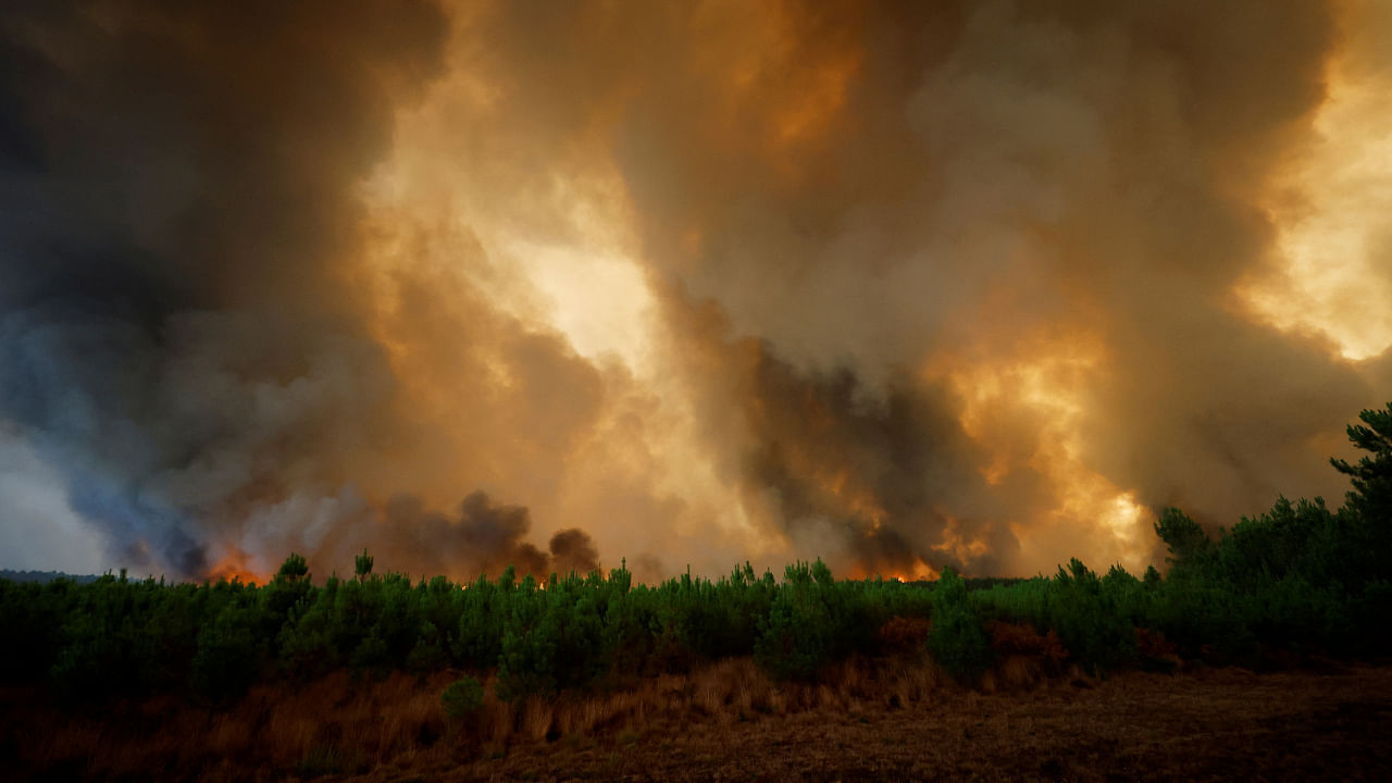 General view of smoke and flames from the fire in Belin-Beliet, as wildfires continue to spread in the Gironde region of southwestern France, August 10, 2022. Credit: Reuters Photo